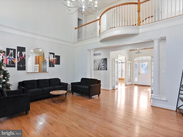 15 Laurel Hill Ct, Gettysburg, PA 17325 - living area with wood finished floors, a towering ceiling, decorative columns, a chandelier, and baseboards