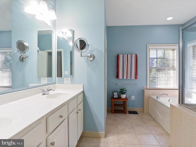 bathroom featuring a bath, tile patterned floors, and vanity