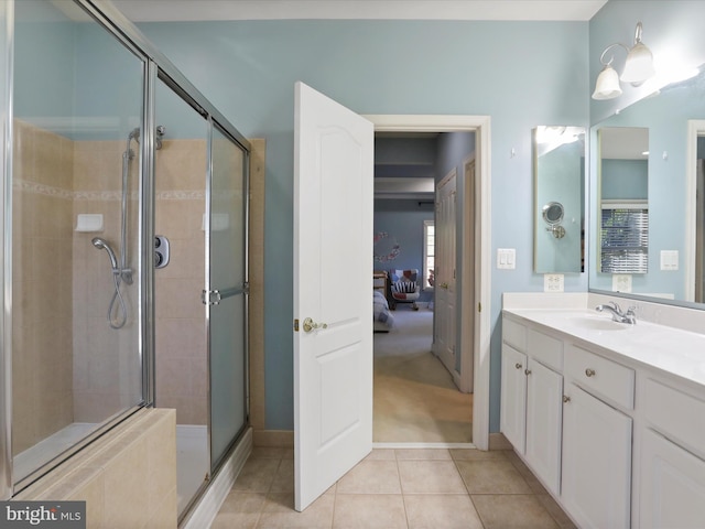 bathroom with vanity, a shower with shower door, and tile patterned floors