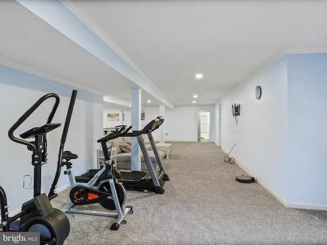 exercise area featuring ornamental molding and light colored carpet