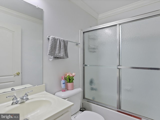 full bathroom with bath / shower combo with glass door, vanity, toilet, and ornamental molding