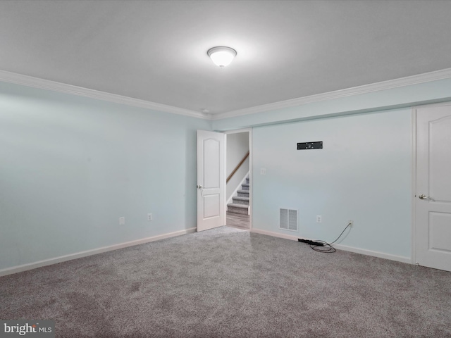 unfurnished room with carpet flooring and crown molding