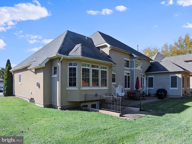 rear view of house featuring a yard and a patio area