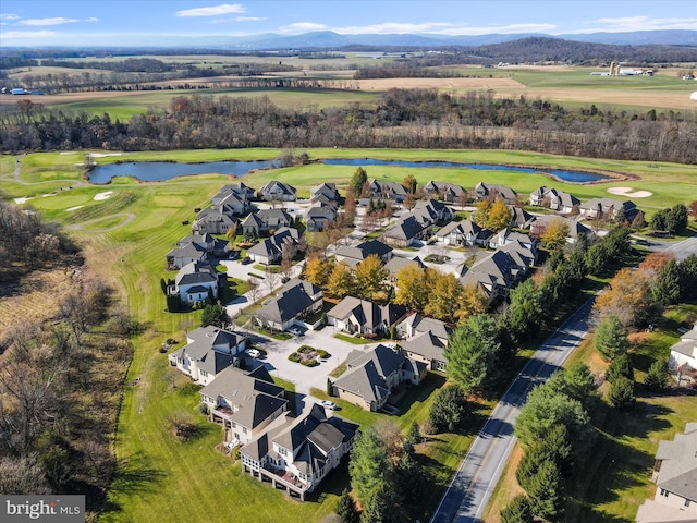 birds eye view of property with a water and mountain view