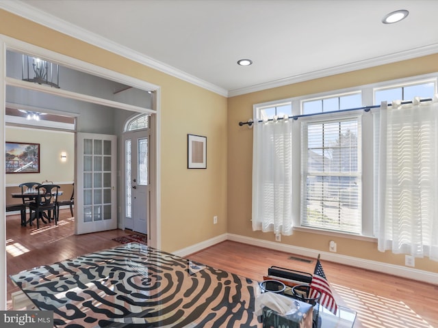 interior space featuring ornamental molding, french doors, a wealth of natural light, and hardwood / wood-style flooring