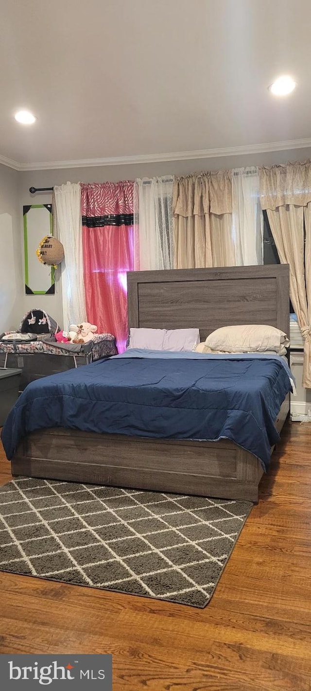 bedroom featuring hardwood / wood-style floors and crown molding