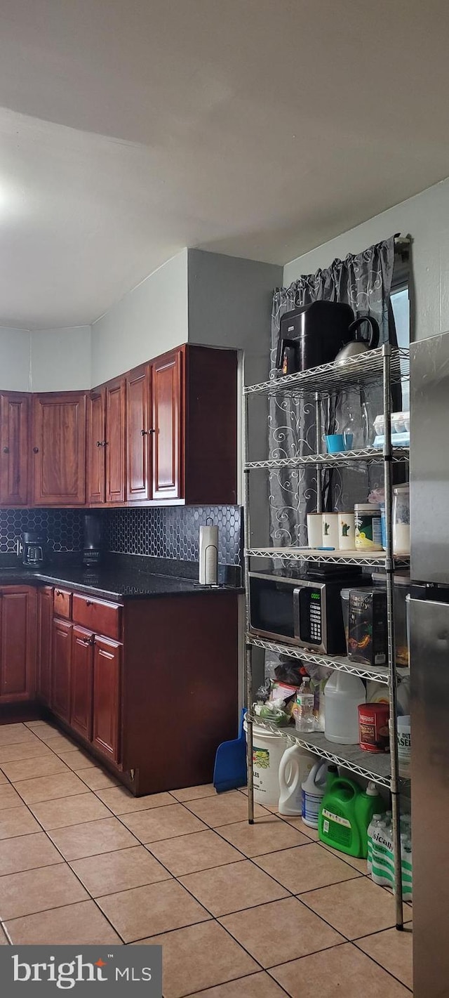 kitchen featuring light tile patterned floors and backsplash