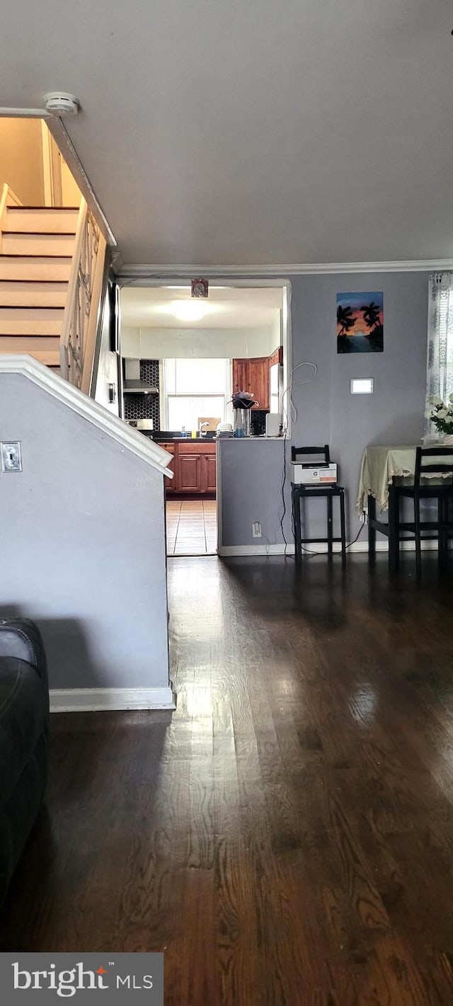 interior space with hardwood / wood-style floors and crown molding