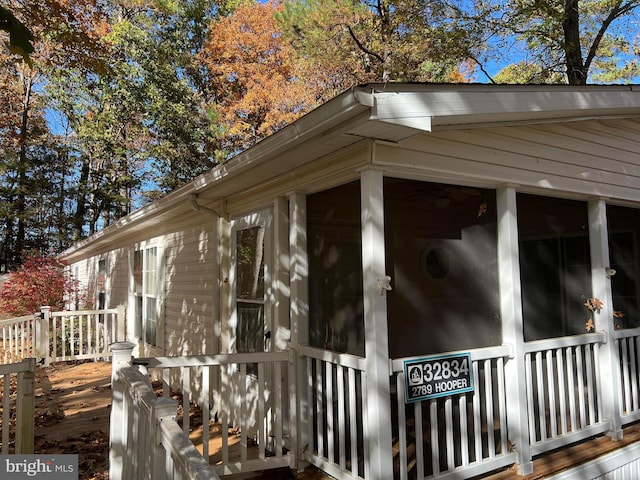 view of side of home featuring a sunroom