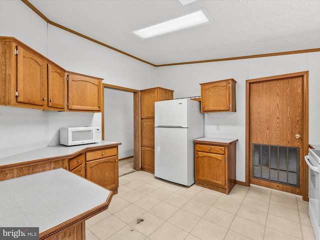 kitchen with ornamental molding, white appliances, a textured ceiling, and lofted ceiling