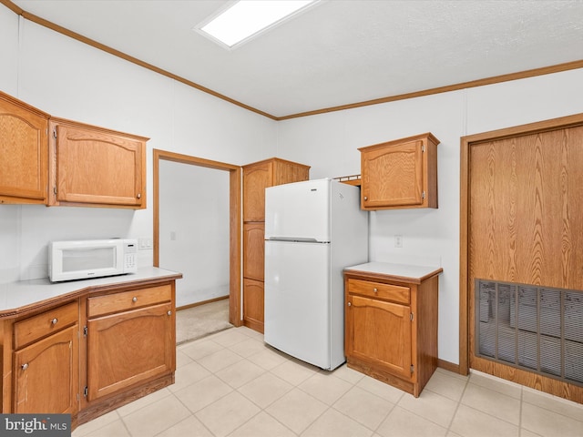 kitchen featuring vaulted ceiling, a textured ceiling, white appliances, and ornamental molding