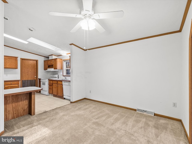 kitchen with ceiling fan, sink, light colored carpet, lofted ceiling, and white appliances