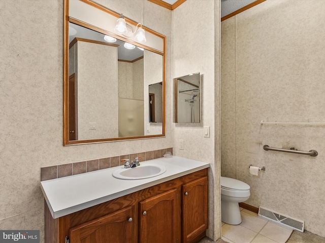 bathroom featuring tile patterned floors, toilet, vanity, and ornamental molding