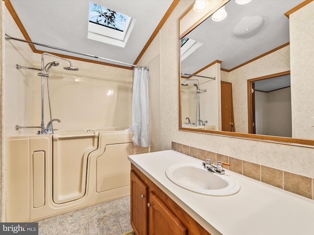 bathroom with ornamental molding, tasteful backsplash, vanity, tile patterned flooring, and lofted ceiling with skylight