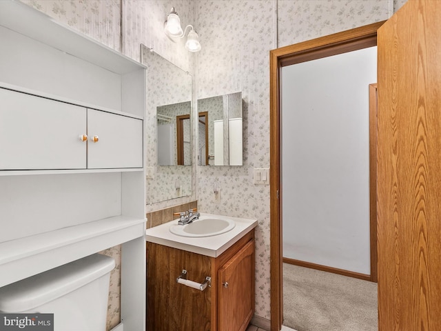 bathroom featuring vanity and toilet