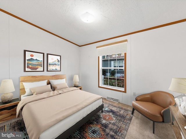 bedroom featuring a textured ceiling and crown molding