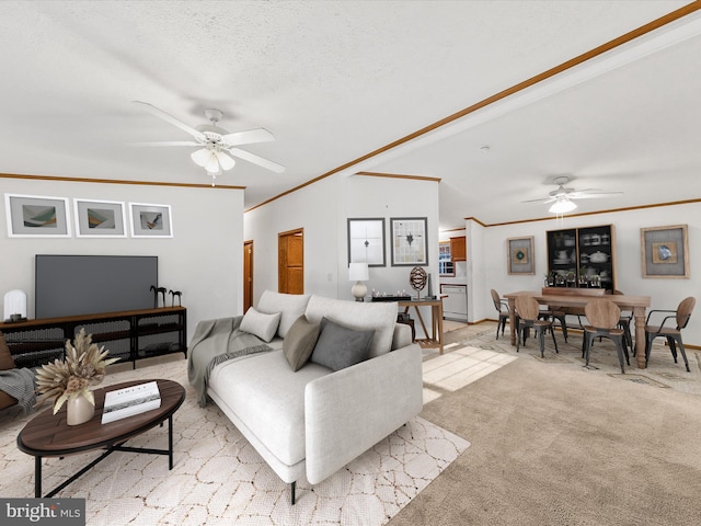 living room featuring ceiling fan, crown molding, and light carpet