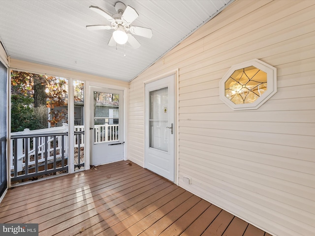 unfurnished sunroom with ceiling fan and lofted ceiling