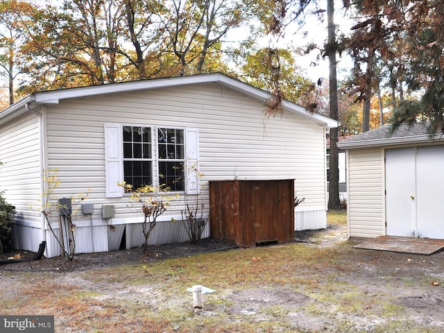 view of property exterior featuring a storage unit