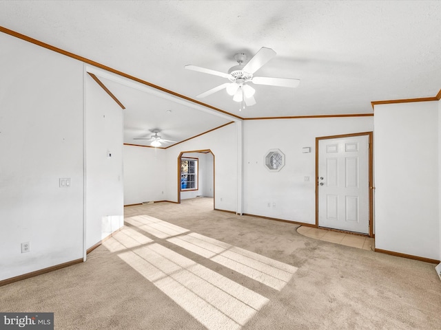 carpeted empty room with ornamental molding, ceiling fan, and lofted ceiling