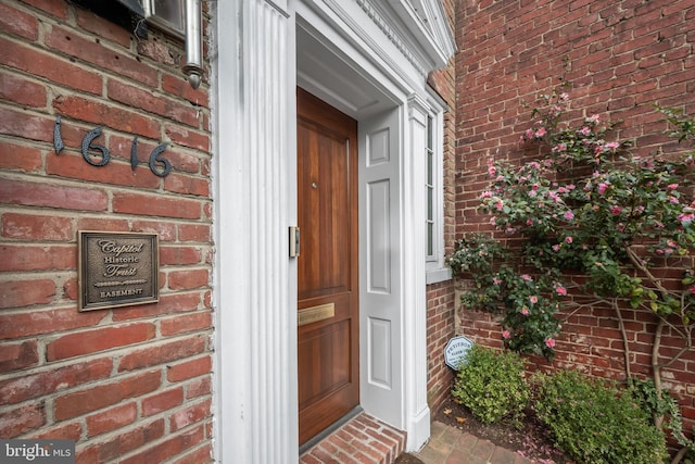 entrance to property with brick siding