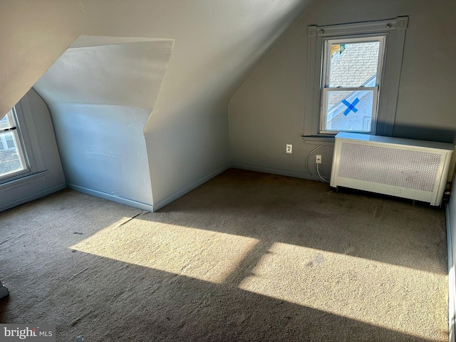 bonus room featuring carpet flooring, radiator heating unit, and vaulted ceiling