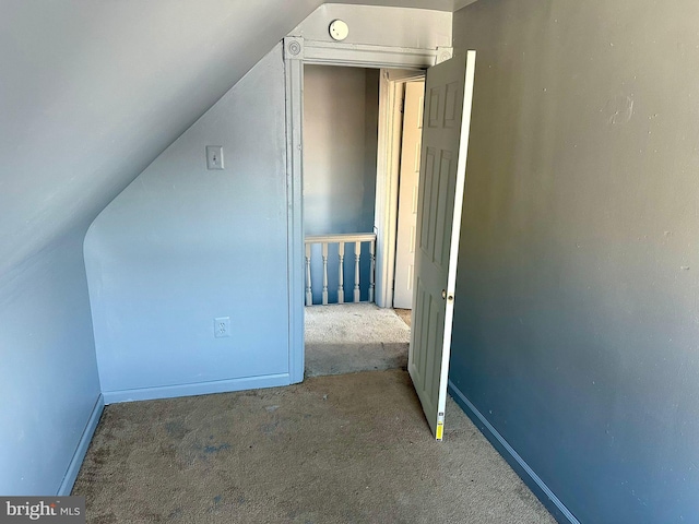 additional living space with carpet floors and vaulted ceiling