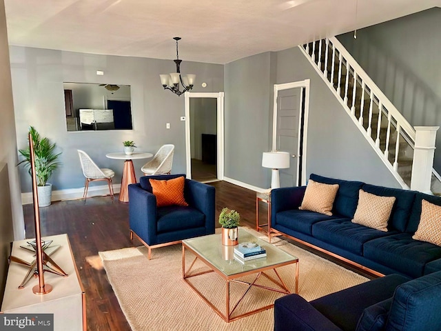 living room with dark hardwood / wood-style floors and an inviting chandelier