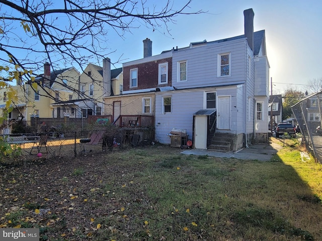 back of property featuring a lawn