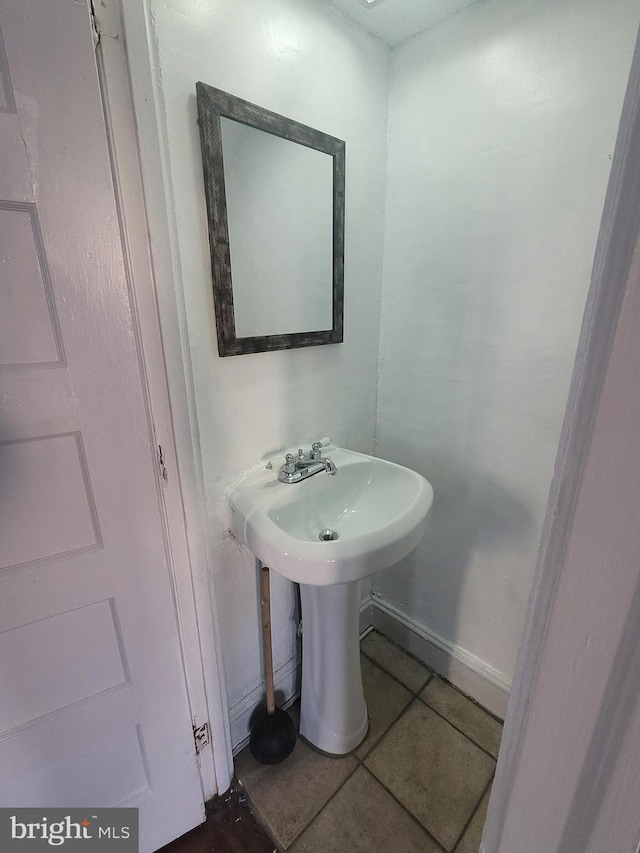 bathroom with tile patterned flooring and sink