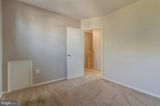 spare room featuring light colored carpet