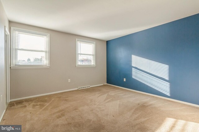 unfurnished room with light carpet