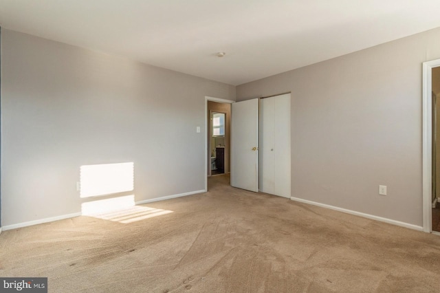 unfurnished room with light colored carpet