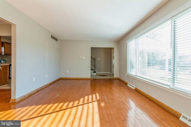 unfurnished living room featuring wood-type flooring