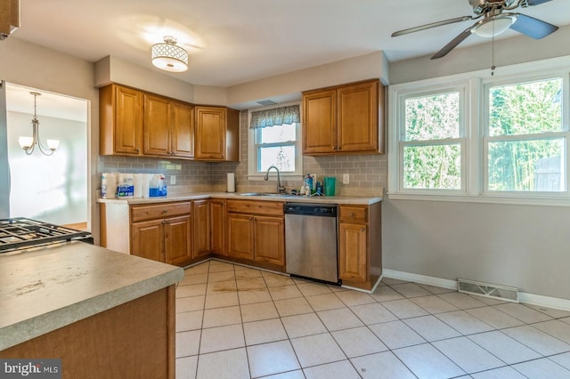 kitchen featuring dishwasher, hanging light fixtures, sink, ceiling fan, and backsplash