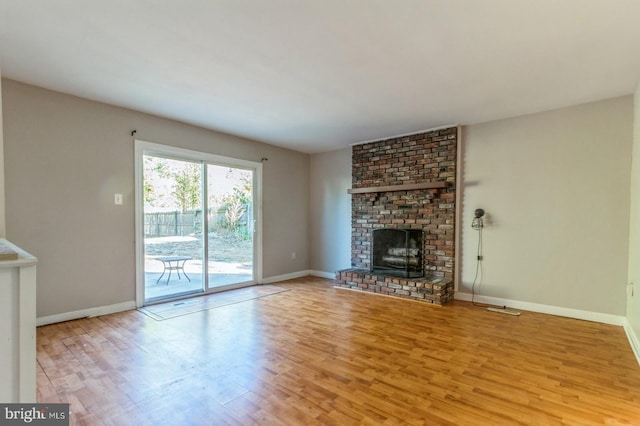 unfurnished living room with a fireplace and light hardwood / wood-style flooring