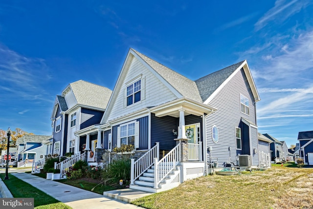 view of front of property featuring cooling unit and a front yard