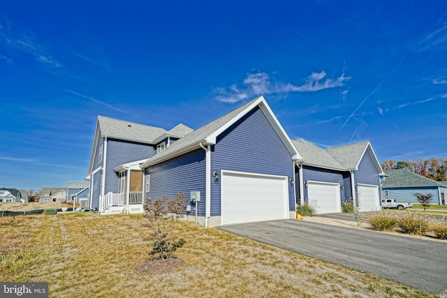 view of home's exterior featuring a garage and a lawn