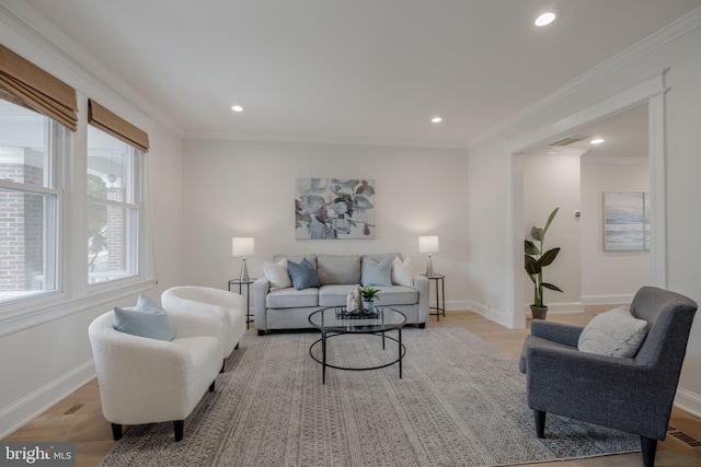 living room with light hardwood / wood-style floors and ornamental molding