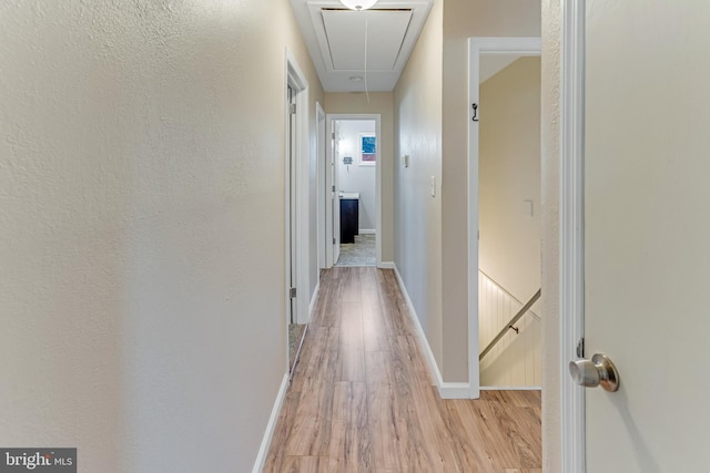 corridor with light hardwood / wood-style flooring