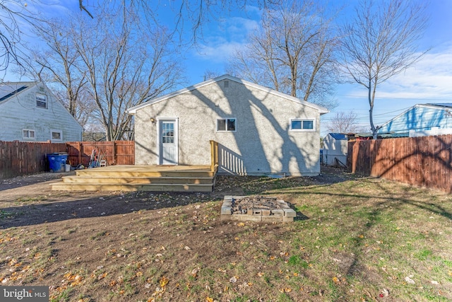 rear view of property featuring a yard and a wooden deck