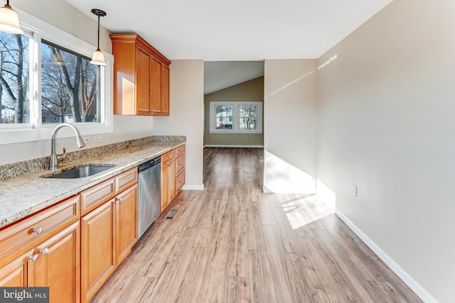 kitchen featuring dishwasher, light hardwood / wood-style floors, plenty of natural light, and sink