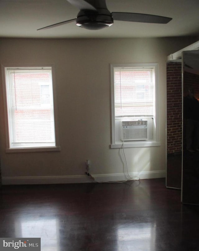 empty room with ceiling fan, cooling unit, and dark wood-type flooring