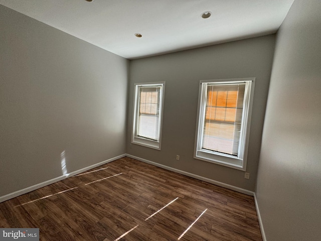 empty room featuring dark wood-type flooring