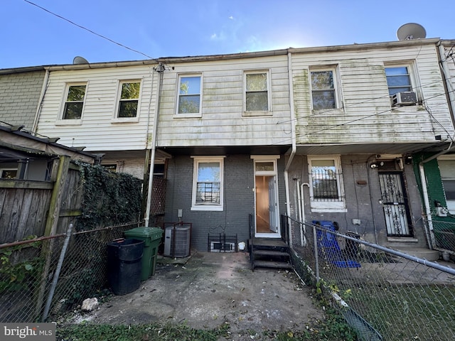 back of house with central AC unit