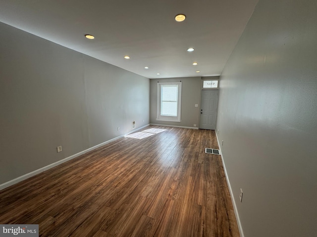 spare room with dark hardwood / wood-style flooring