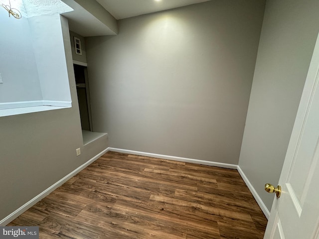 unfurnished room featuring dark hardwood / wood-style flooring