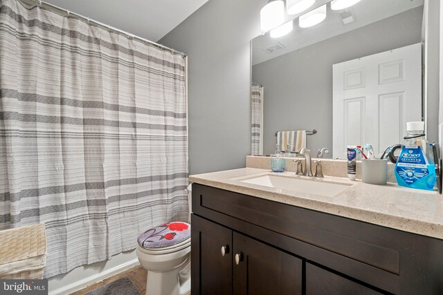 full bathroom featuring vanity, toilet, and shower / tub combo with curtain