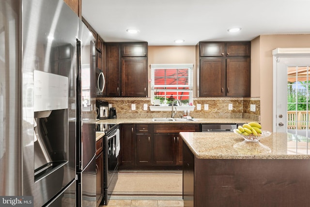 kitchen with decorative backsplash, light stone countertops, sink, and stainless steel appliances