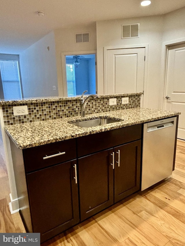 kitchen featuring dishwasher, light wood-type flooring, sink, and dark brown cabinets